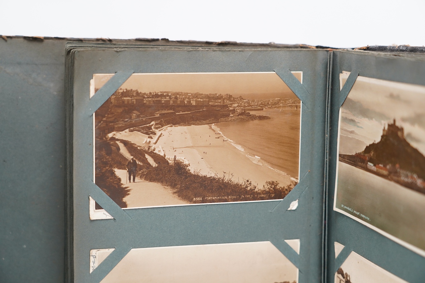 An Edwardian ‘The Cabinet’ postcard album, containing Edwardian and later postcards, mostly topographical. Condition - fair